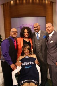 Regina Roberts, 62, of Murrieta will be featured Wednesday on the Steve Harvey Show in a segment called Harvey’s Heroes. Behind her are DeShae Bell, LyNea Bell, Steve Harvey and McClain Bell. Courtesy photo( / Courtesy photo)