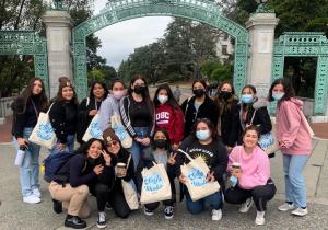 Female high school students pose in front of UC Berkeley's Sather Gate.