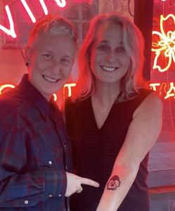 Tattooist and founder of the A Thousand Pansies project, Cedre Csillagi (left), poses with early Pansy tattoo recipient Piper Kerman, author of Orange Is The New Black in front of the Diving Swallow Tattoo Shop in Oakland, CA.