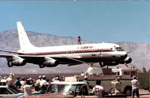 The Human Fly Standing on Top of his Personalized DC-8 Jet in the air